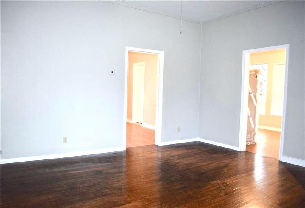 611 Nelray Boulevard, Unit B Austin, TX 78751 - Photo 3 of 11 a view of an empty room with wooden floor and a window