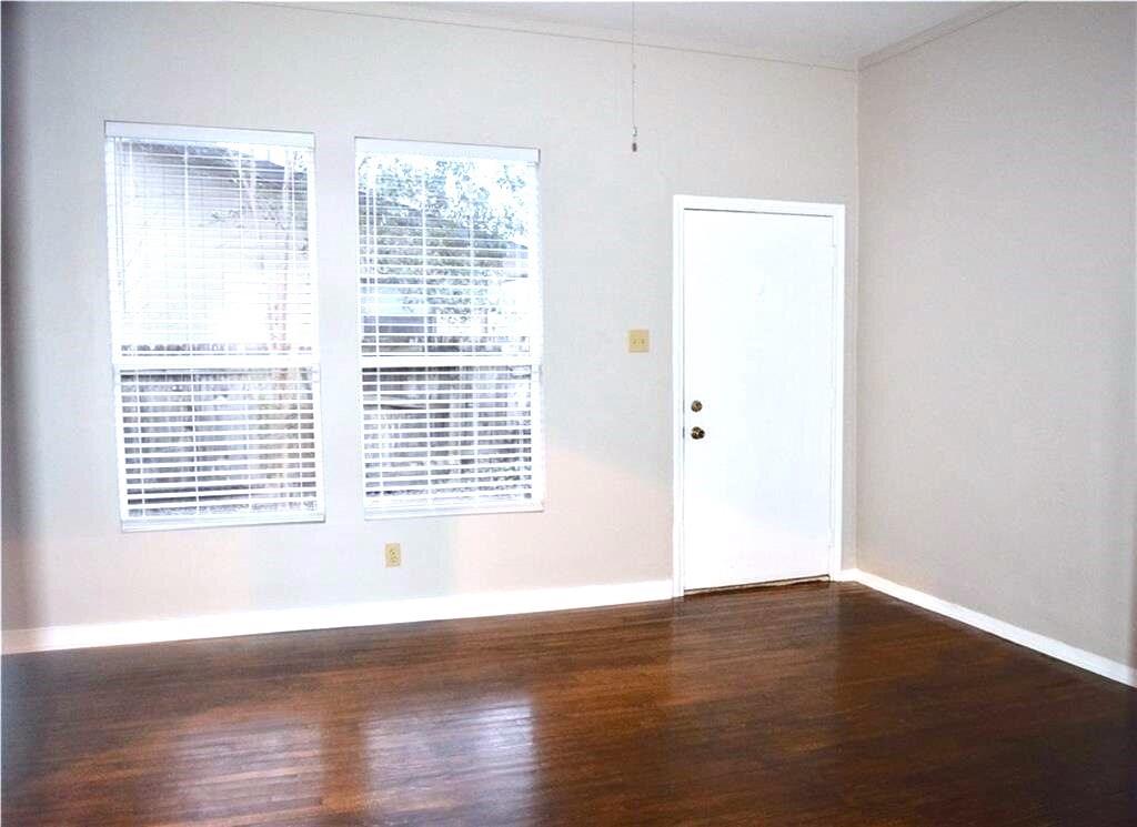611 Nelray Boulevard, Unit B Austin, TX 78751 - Photo 5 of 11 a view of an empty room with wooden floor and a window