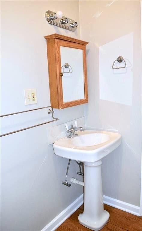 611 Nelray Boulevard, Unit B Austin, TX 78751 - Photo 7 of 11 a bathroom with a sink a mirror and vanity