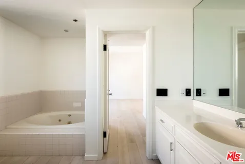 a bathroom with a sink double vanity and a mirror