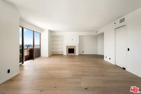 a view of empty room with a fireplace