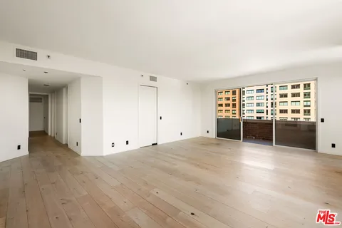 a kitchen with a refrigerator sink and cabinets
