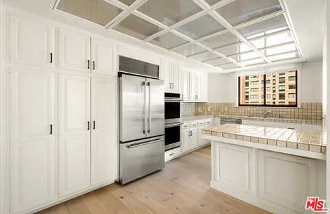 a kitchen with stainless steel appliances a refrigerator and a stove