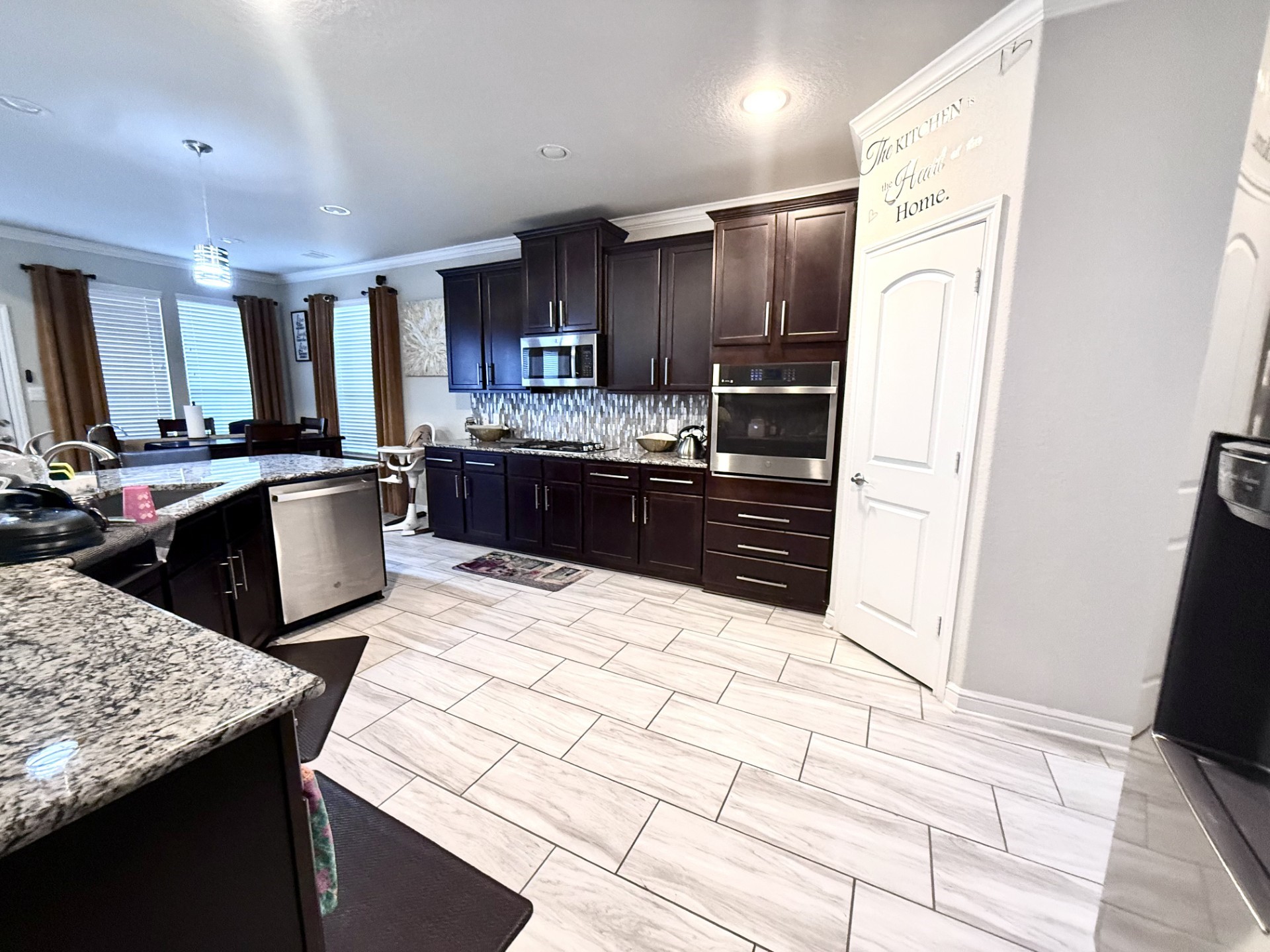 4811 Lacebark Pne Trail Rosenberg, TX 77471 - Photo 10 of 31 a kitchen with stainless steel appliances kitchen island granite countertop a refrigerator and a stove top oven