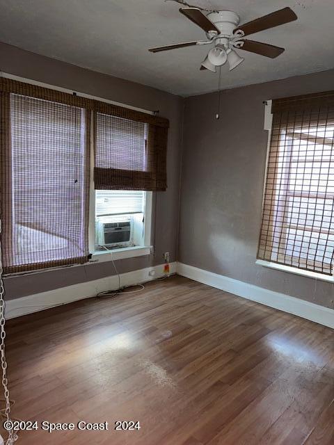 1219 East Strawbridge Avenue, Unit 4 Melbourne, FL 32901 - Photo 4 of 9 a view of an empty room with wooden floor and a window