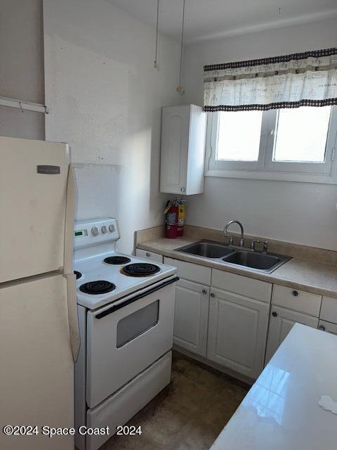 1219 East Strawbridge Avenue, Unit 4 Melbourne, FL 32901 - Photo 7 of 9 a kitchen with stainless steel appliances a sink stove and a refrigerator