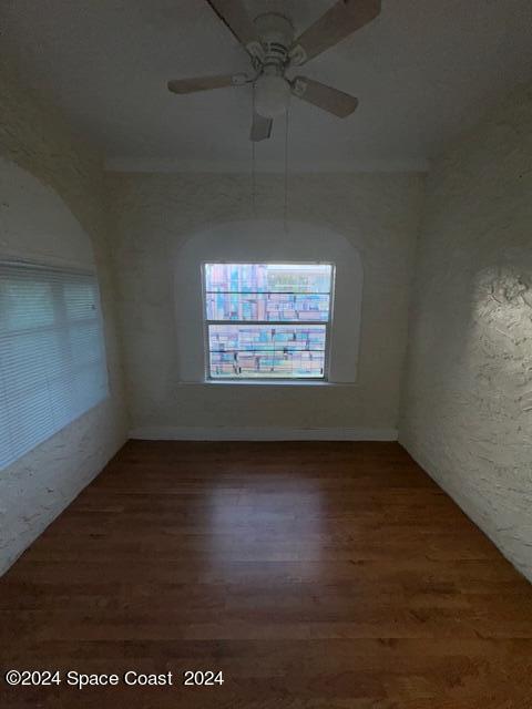 1219 East Strawbridge Avenue, Unit 4 Melbourne, FL 32901 - Photo 9 of 9 an empty room with wooden floor and windows