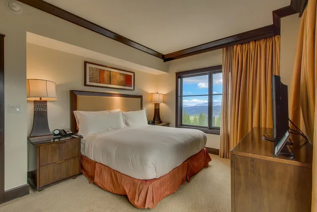 a spacious bedroom with two beds and a couch