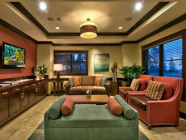 a dining room with furniture and a chandelier