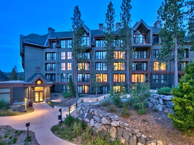 a backyard of a house with barbeque oven table and chairs