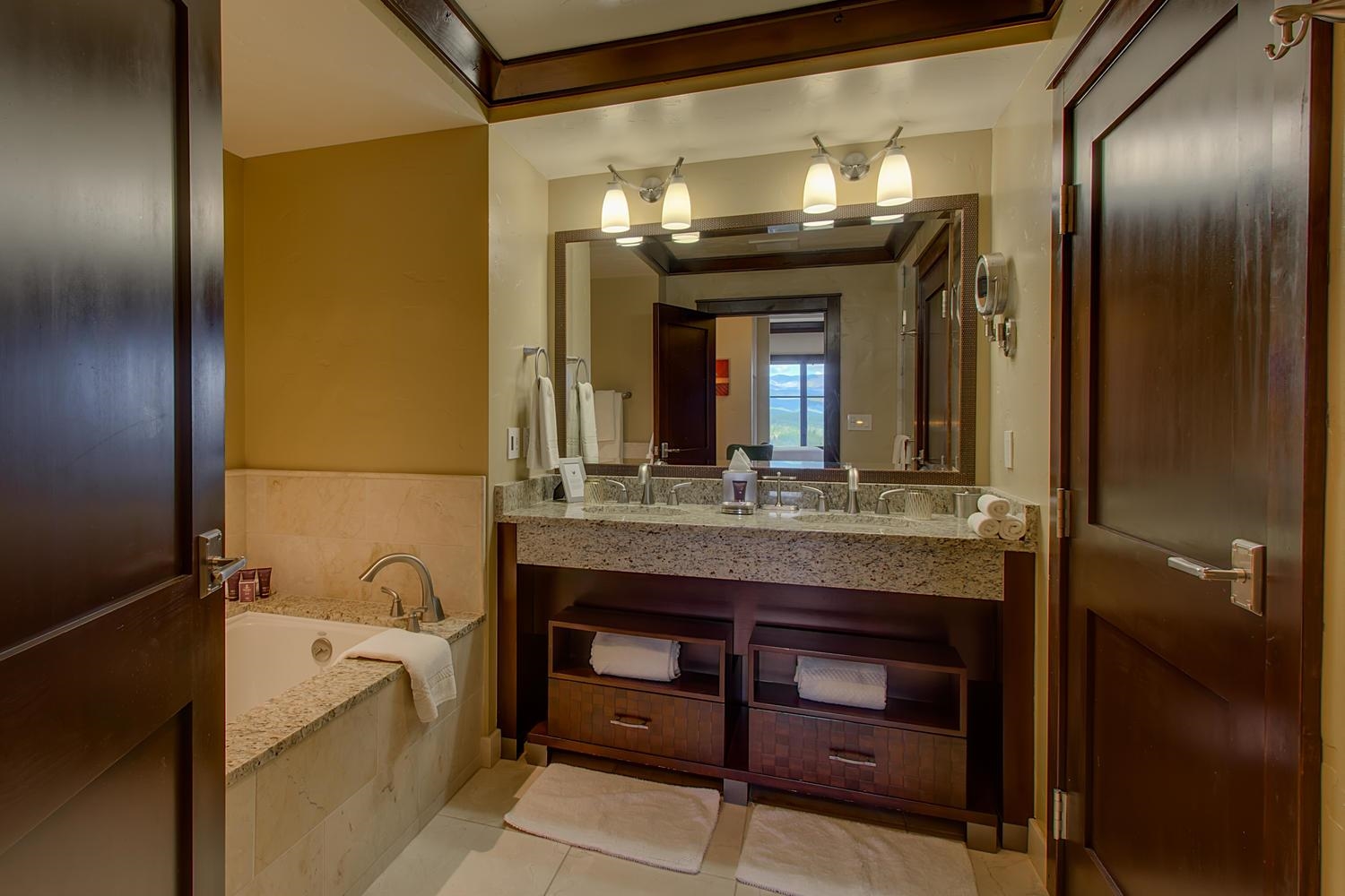13051 Ritz Carlton Highlands Court, Unit 4308 INTEREST 8 Truckee, CA 96161 - Photo 4 of 26 a bathroom with a granite countertop sink a large mirror and a bathtub