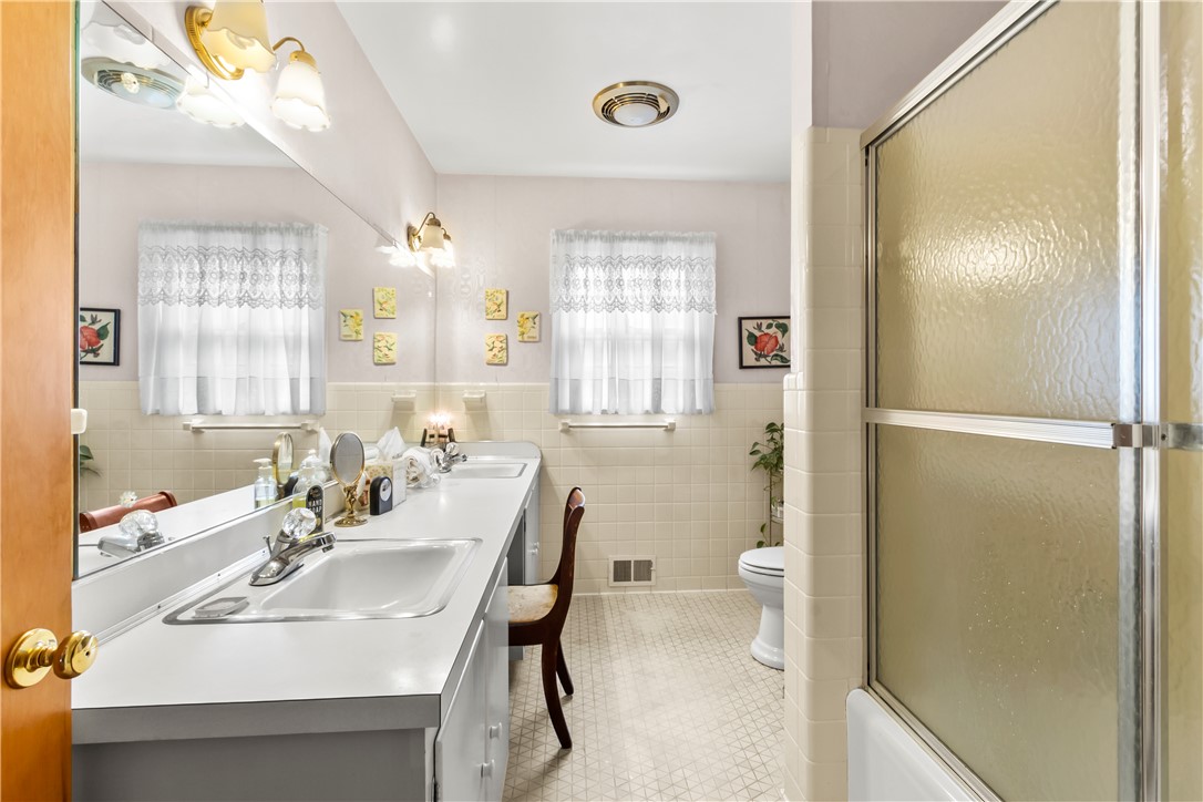 118 Blair Road Belton, SC 29627 - Photo 16 of 49 Tiled walls and a long vanity with dual sinks define this classic bathroom space.
