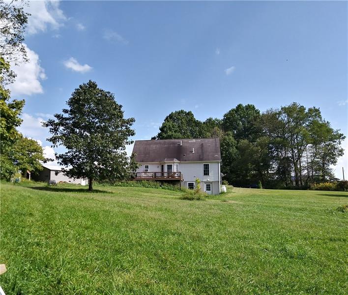 105 Elliott Road Grove City, PA 16127 - Photo 3 of 20 Loads of cleared lawn as well as wooded area can be found in the rear of this property. Deck wraps from side to rear with hot tub and electric hookup on deck for a camper and the full basement is walk-out