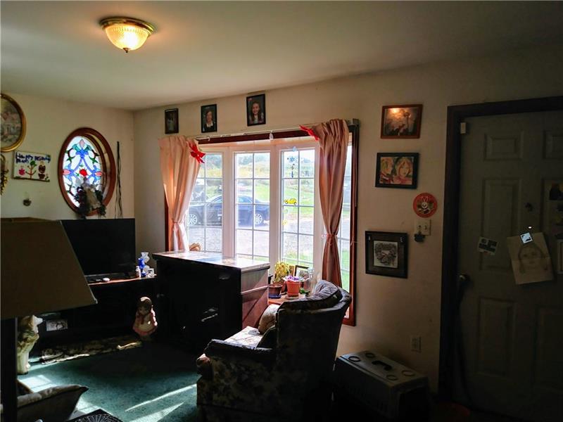 105 Elliott Road Grove City, PA 16127 - Photo 5 of 20 Front Living Room has beautiful stained glass oval accent window and wide bay front window.