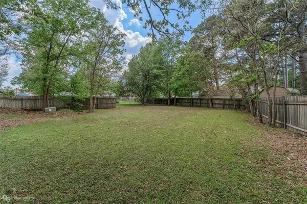 a backyard of a house with trampoline