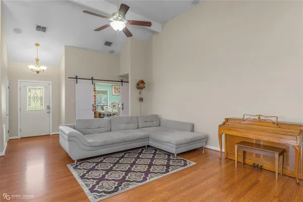a living room with furniture and a wooden floor
