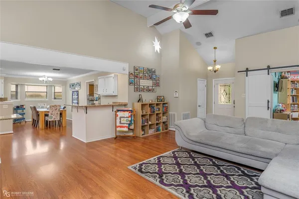 a living room with lots of furniture and kitchen view