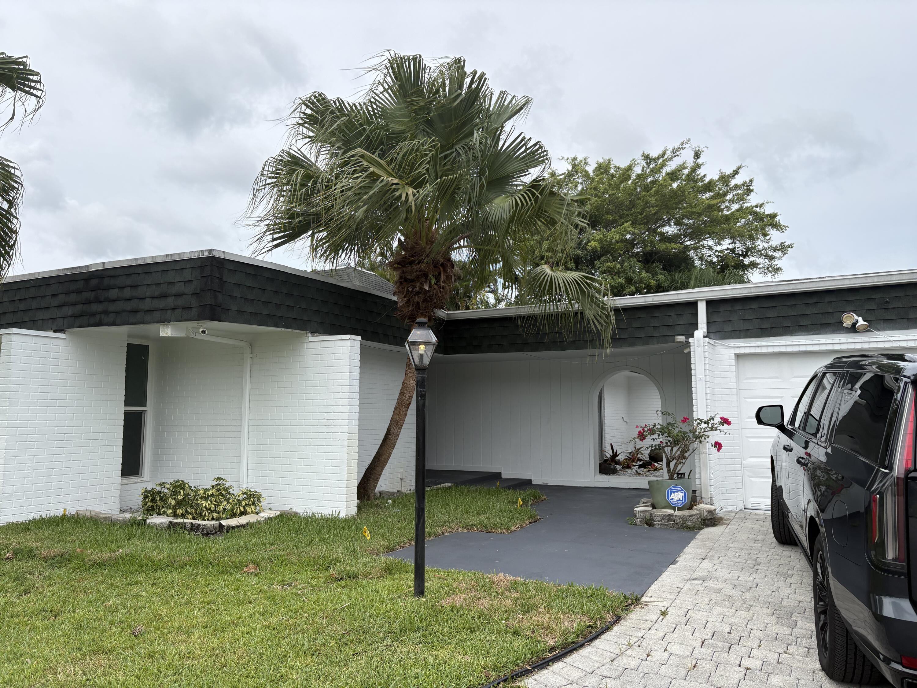 5904 Cedar Circle Tamarac, FL 33319 - Photo 1 of 23 a view of a car garage