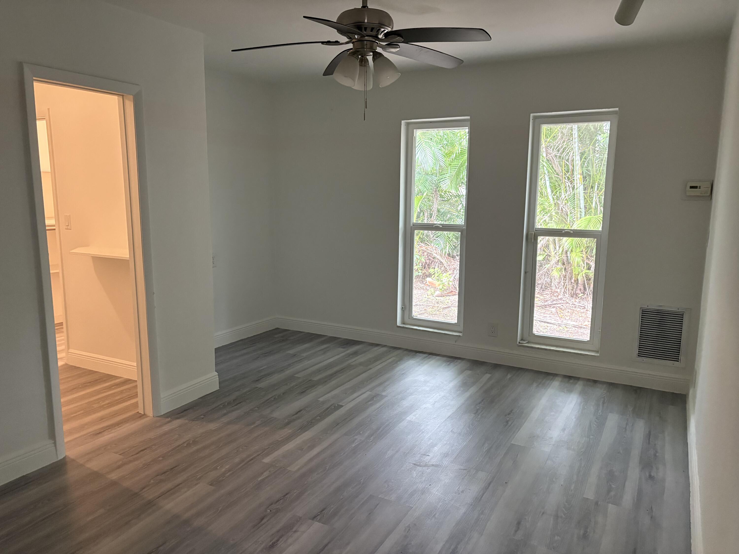 5904 Cedar Circle Tamarac, FL 33319 - Photo 16 of 23 wooden floor in an empty room with a window