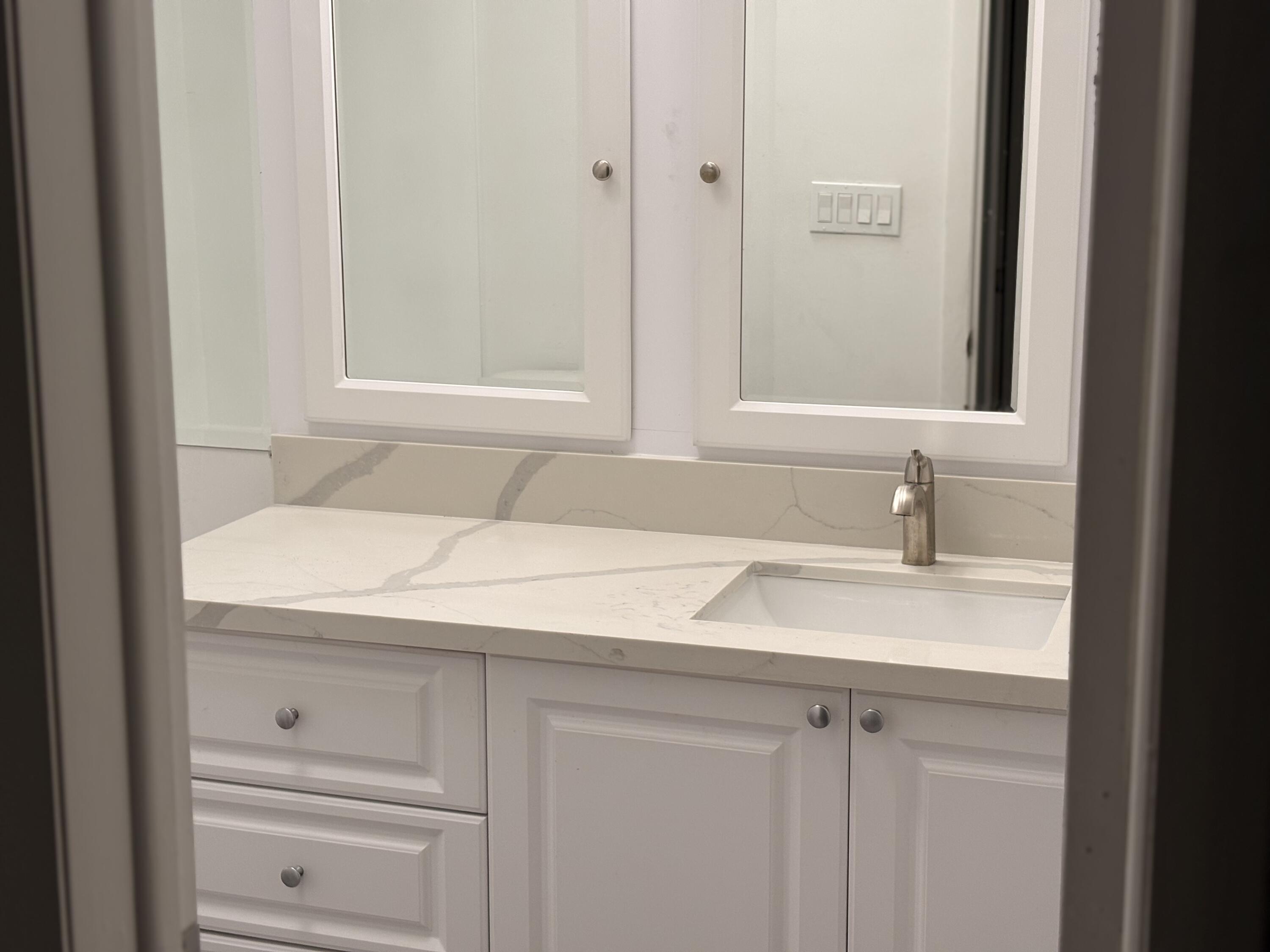 5904 Cedar Circle Tamarac, FL 33319 - Photo 20 of 23 a bathroom with a sink and a mirror