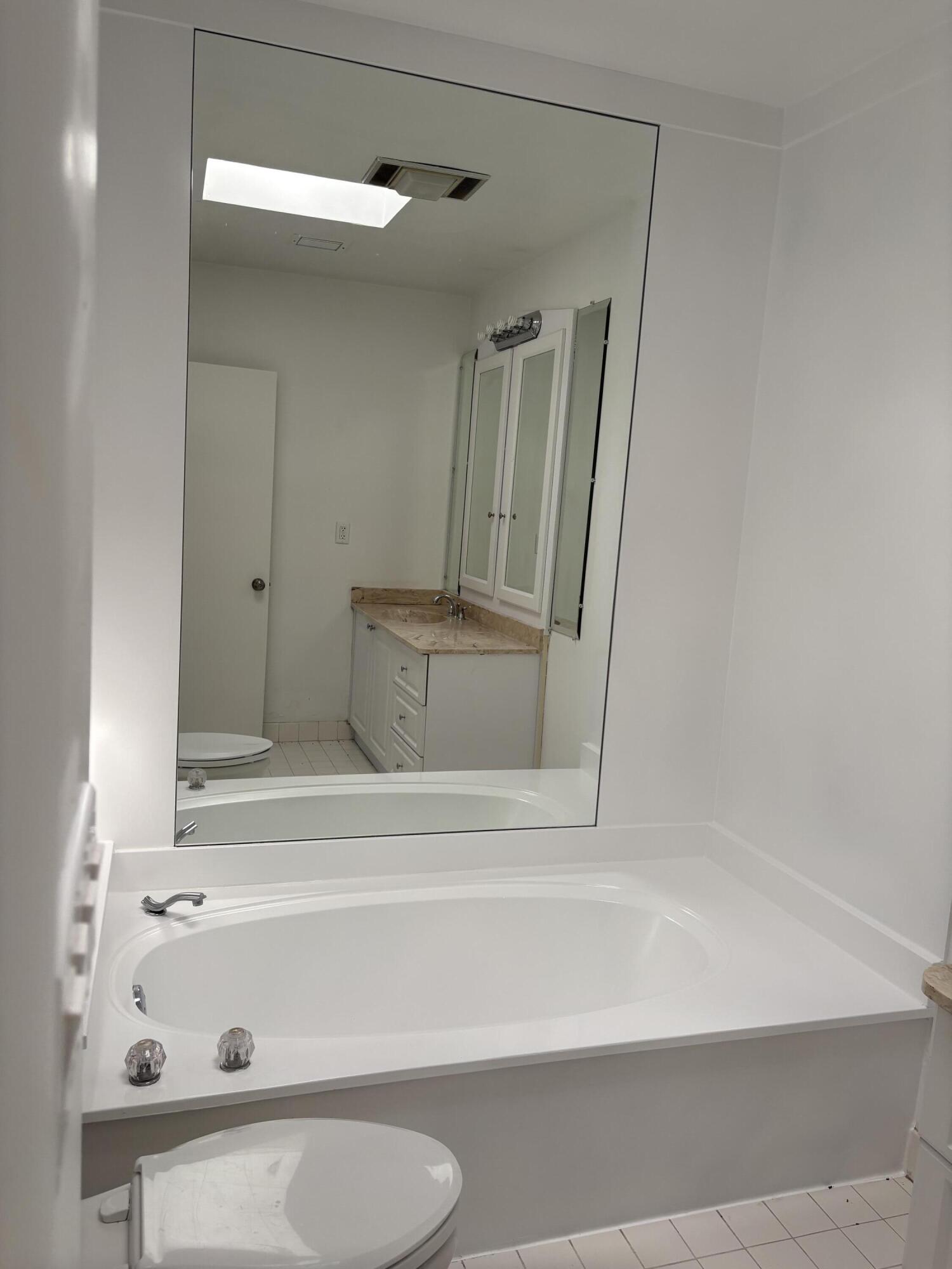 5904 Cedar Circle Tamarac, FL 33319 - Photo 21 of 23 a bathroom with a bathtub and a shower