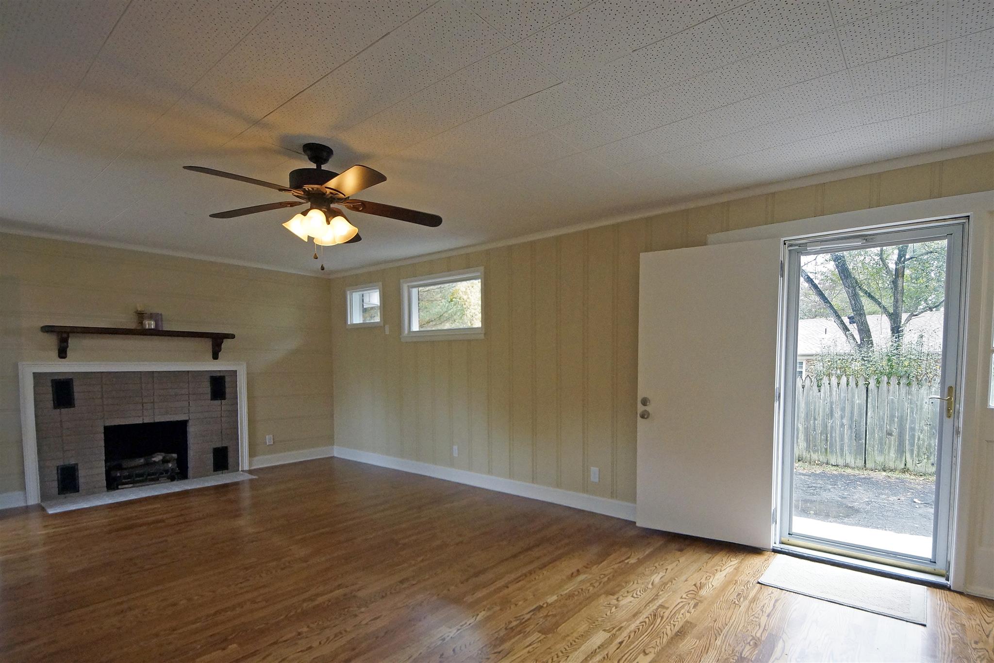 807 River Pass Madison, TN 37115 - Photo 14 of 25 a view of an empty room with wooden floor fireplace and a window