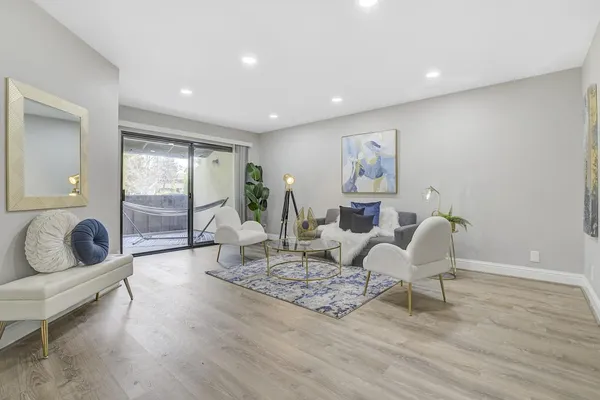 a living room with furniture and a wooden floor