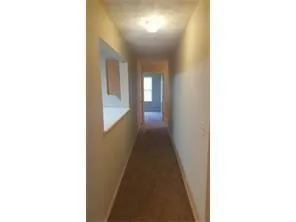 a view of a hallway with a white walls