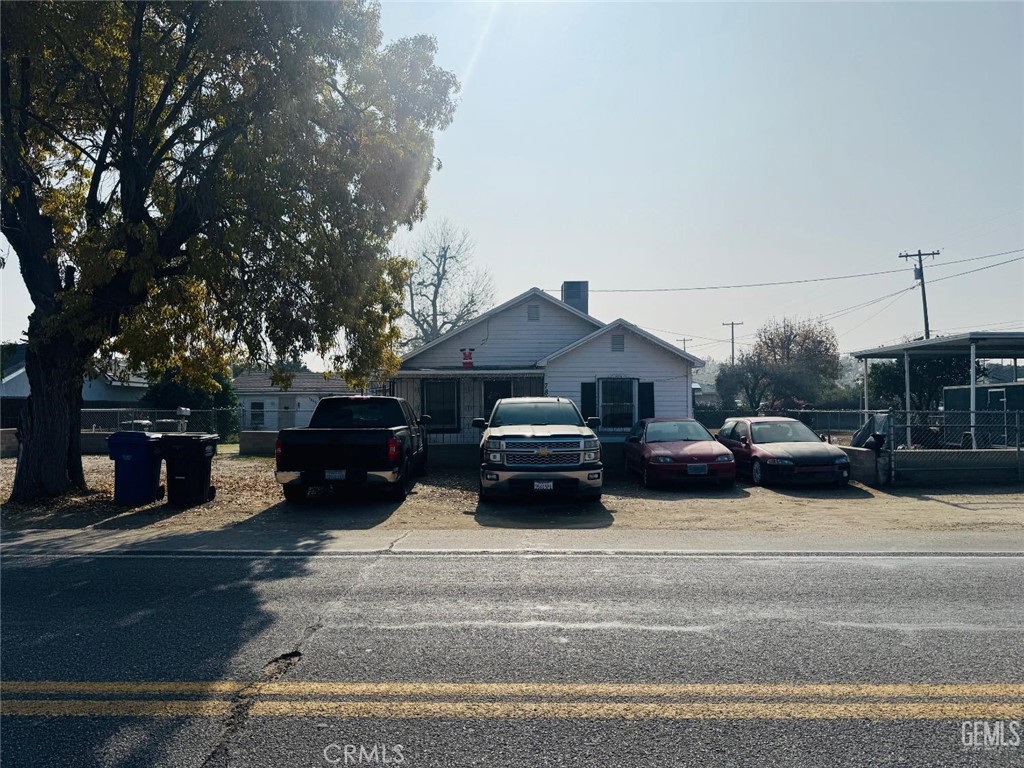 a house view with a sitting space fire pit and outdoor space