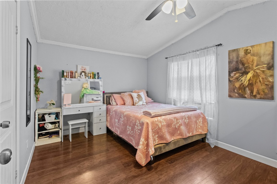 706 11th Street San Leon, TX 77539 - Photo 11 of 20 a bedroom with a bed and a chandelier