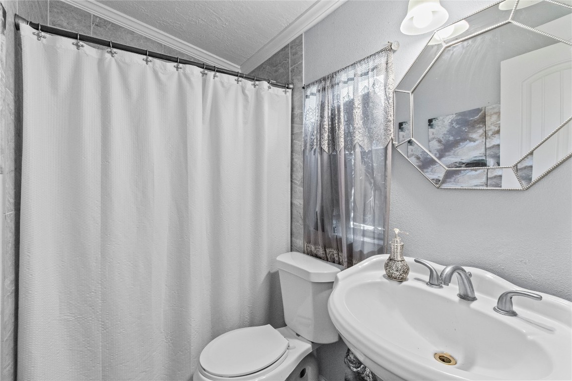 706 11th Street San Leon, TX 77539 - Photo 12 of 20 a bathroom with a sink and a mirror
