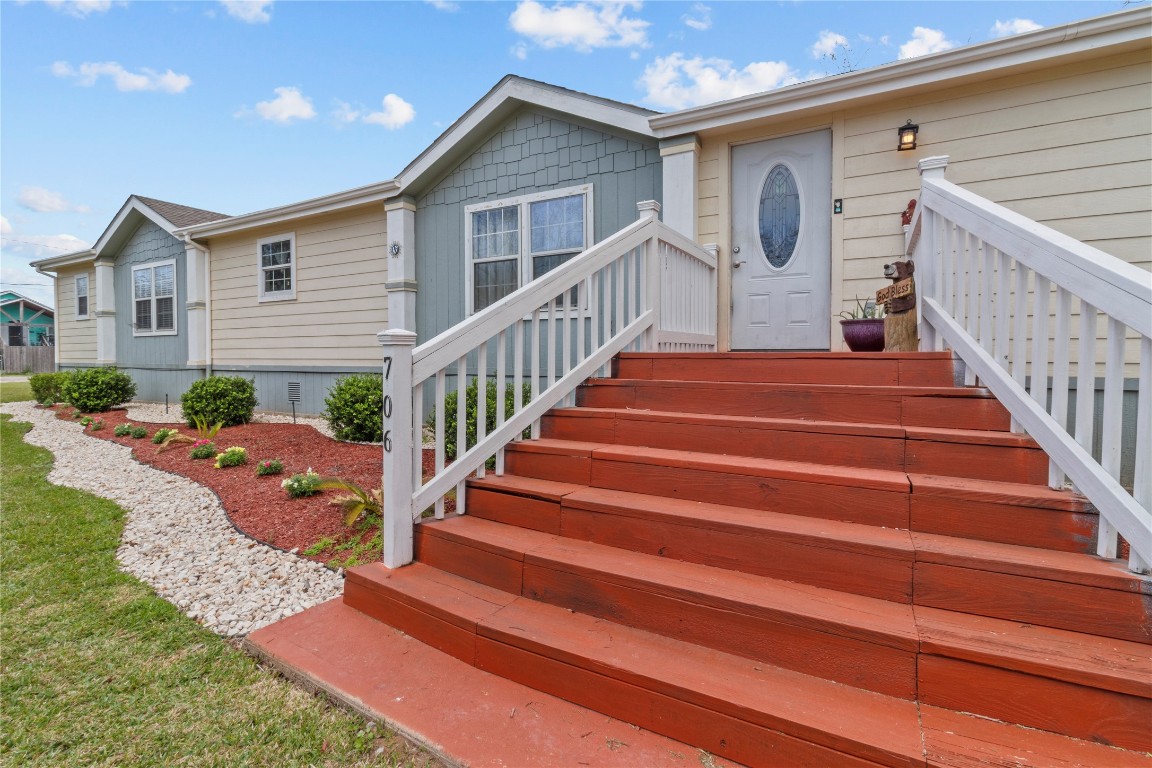 706 11th Street San Leon, TX 77539 - Photo 13 of 20 Enter the home with plenty of stair room, creating a welcoming entry that flows into the bright open-concept living area—perfect for entertaining or everyday family life.