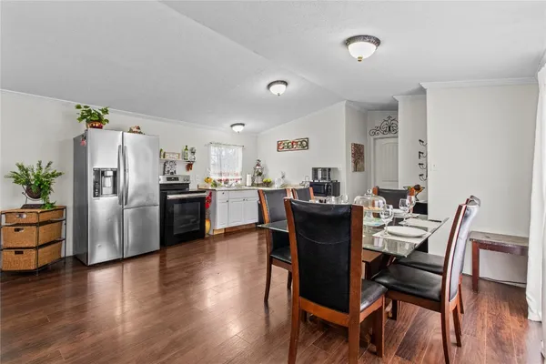 a view of a dining room with furniture and wooden floor