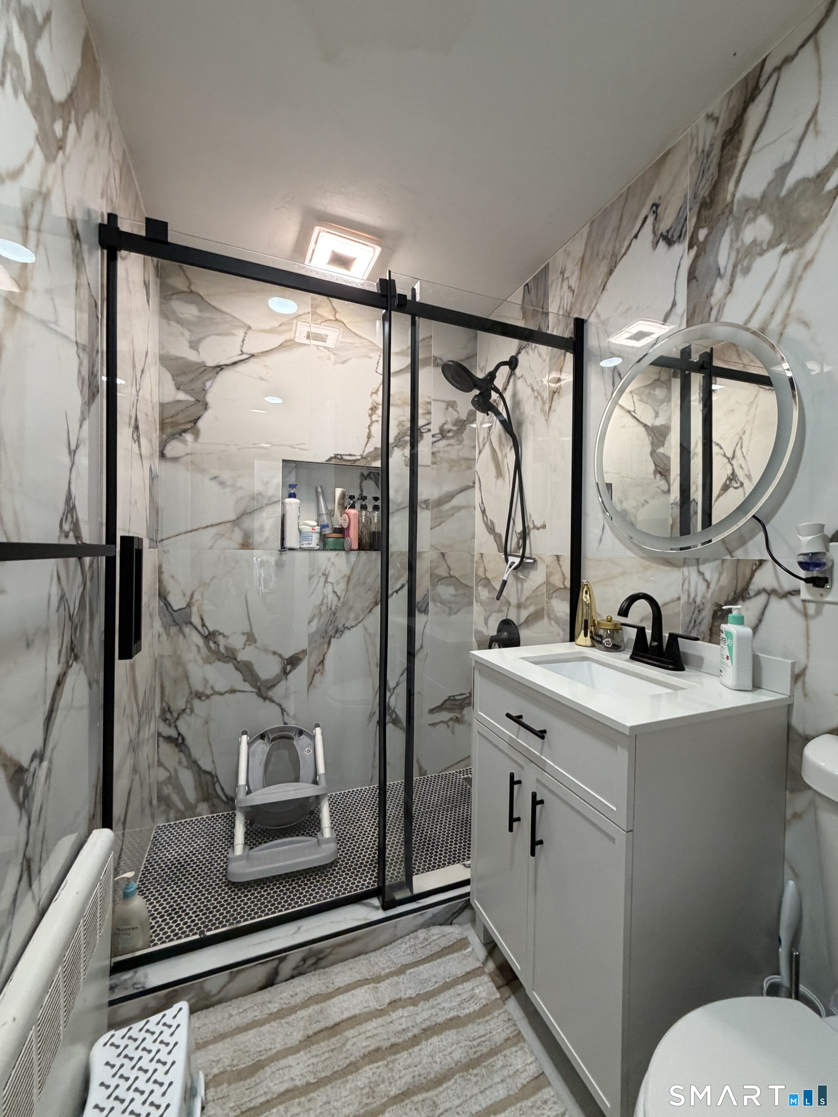 19 Maple Street Plainville, CT 06062 - Photo 12 of 25 a bathroom with a granite countertop sink mirror and toilet