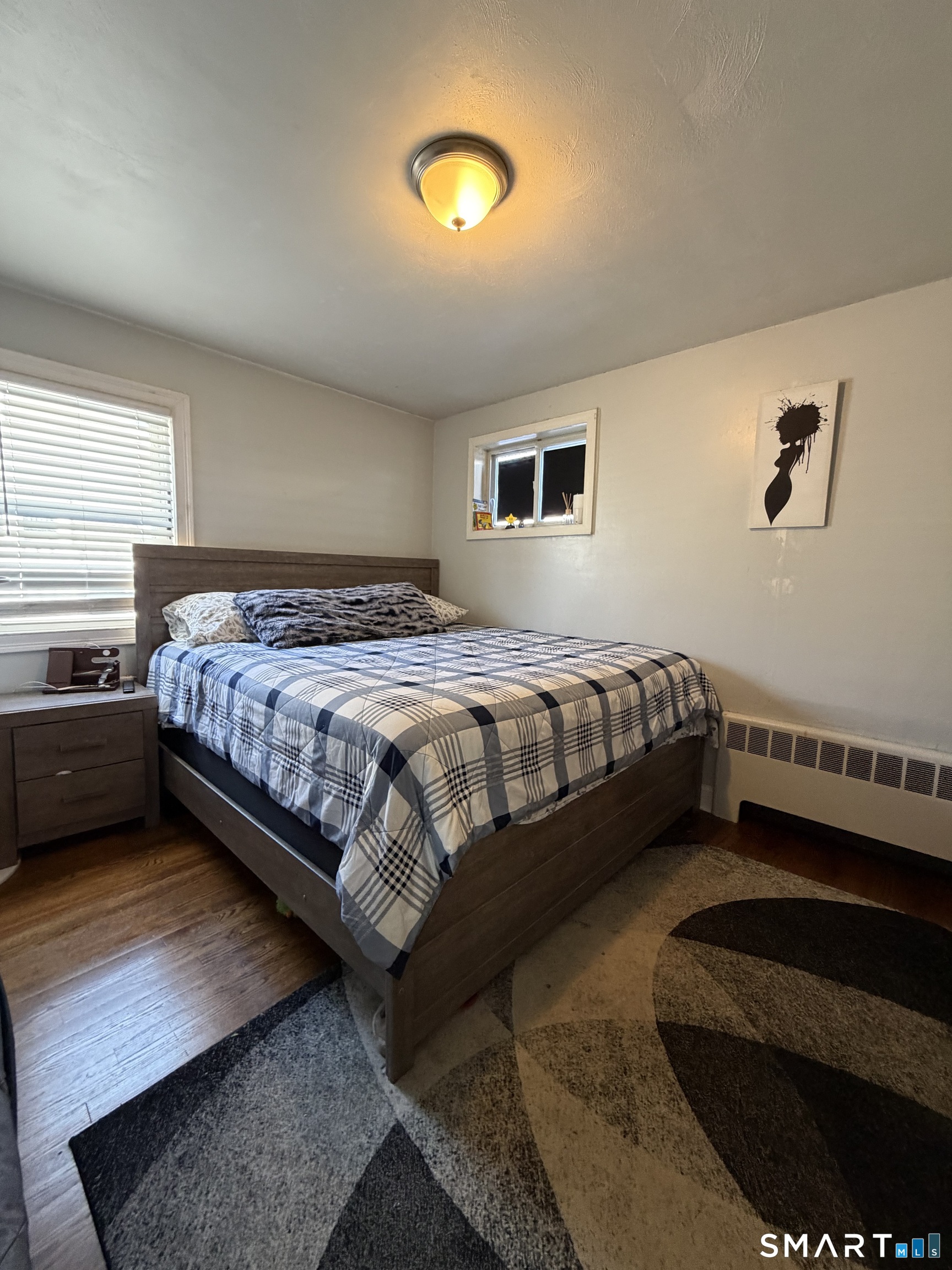 19 Maple Street Plainville, CT 06062 - Photo 14 of 25 a bedroom with a bed and a night stand