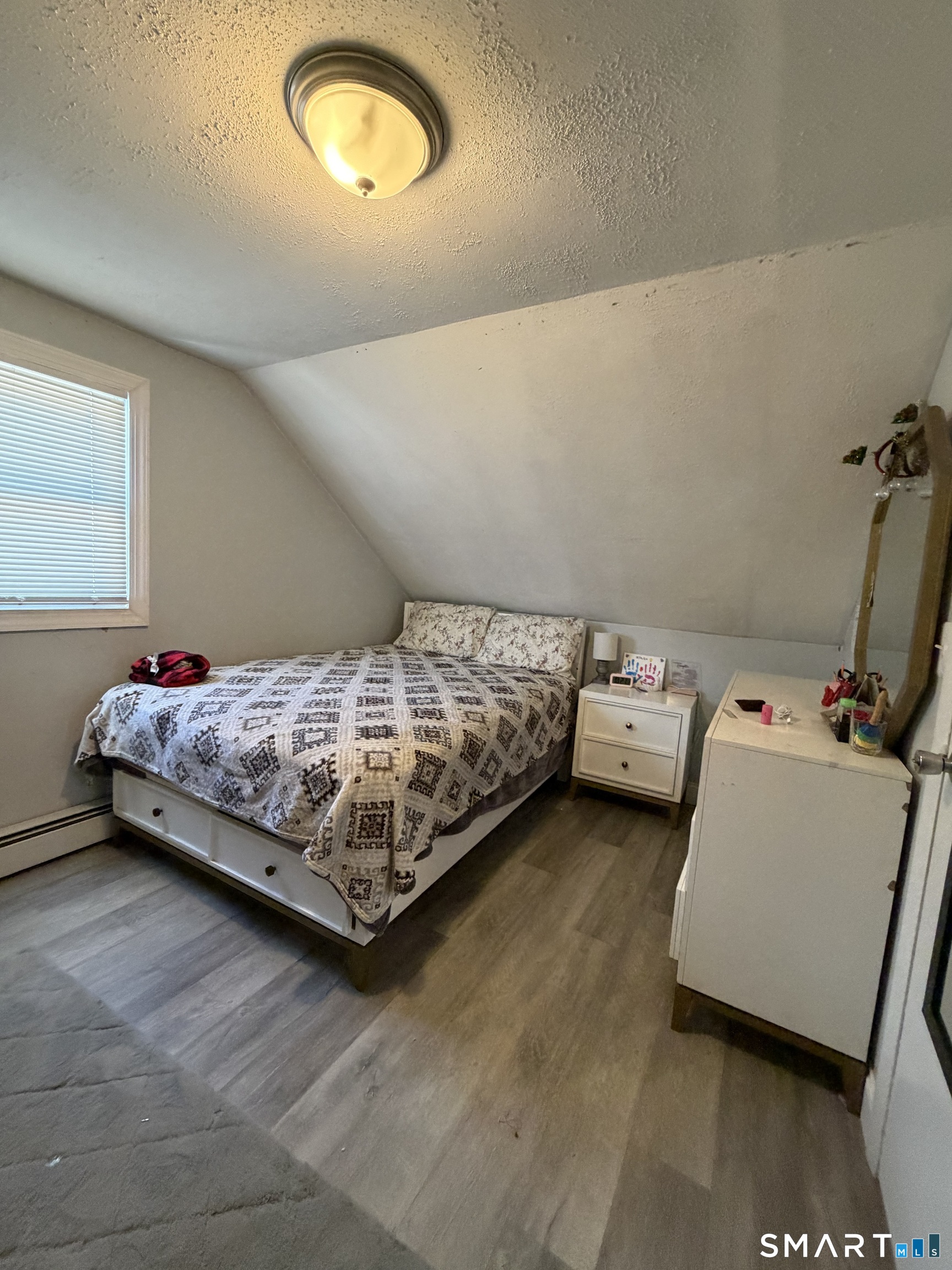 19 Maple Street Plainville, CT 06062 - Photo 18 of 25 a bedroom with a bed and a couch