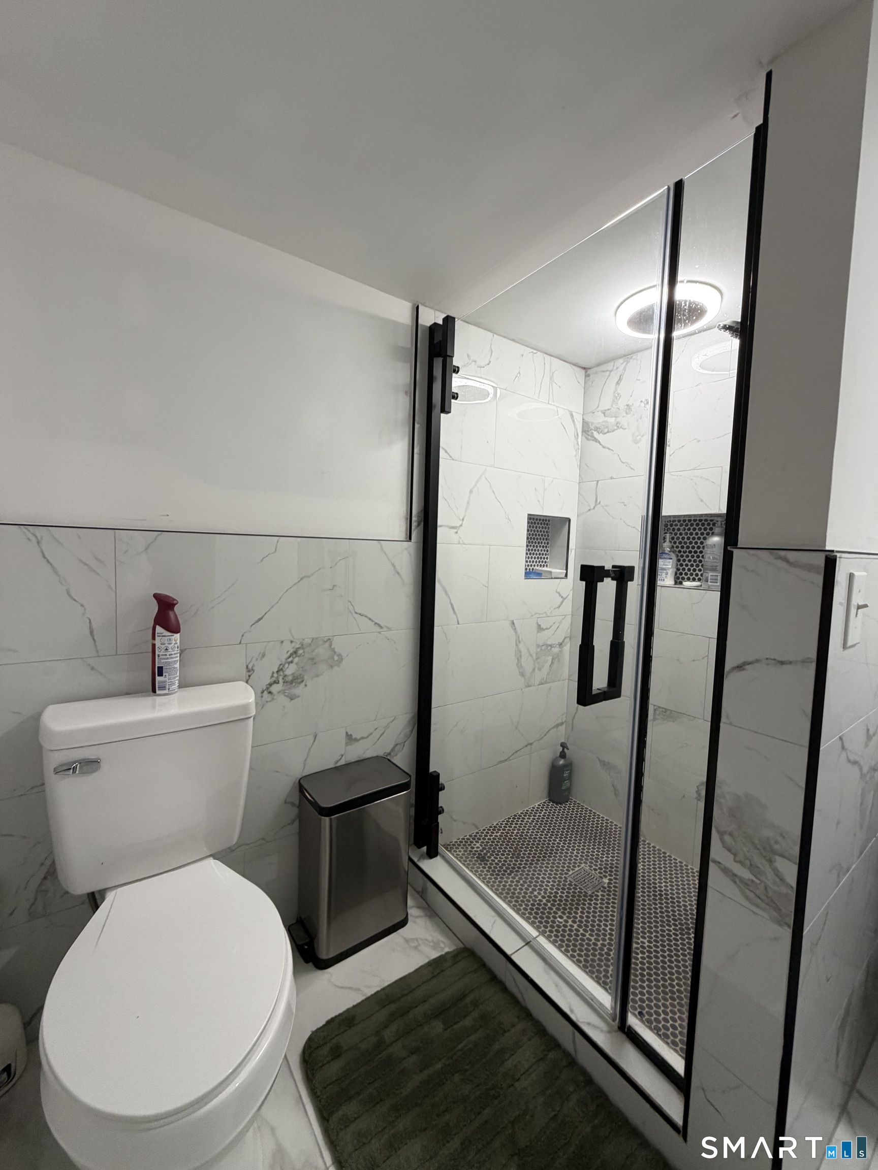 19 Maple Street Plainville, CT 06062 - Photo 23 of 25 a bathroom with a toilet and a shower