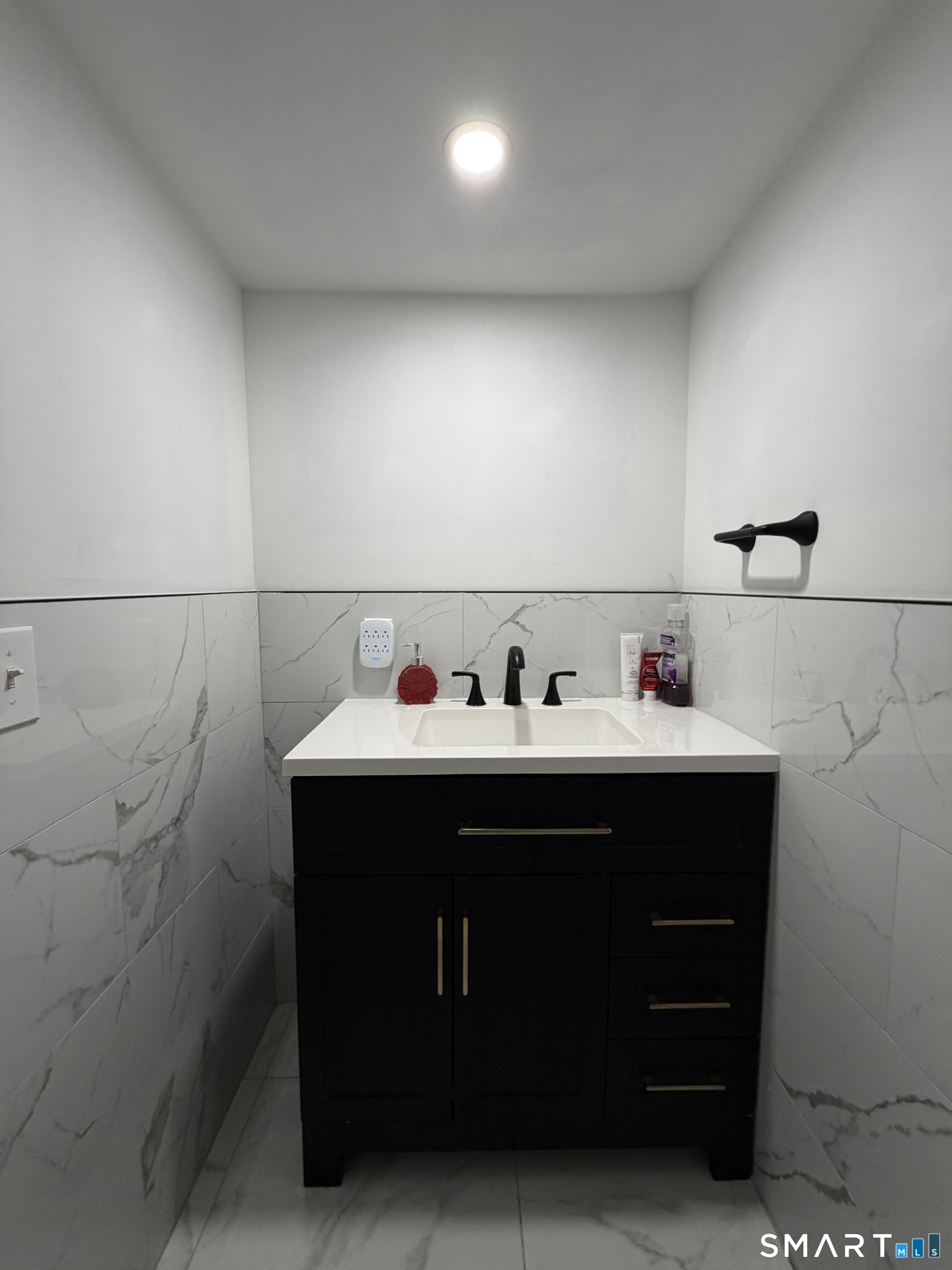 19 Maple Street Plainville, CT 06062 - Photo 24 of 25 a bathroom with a sink and cabinets