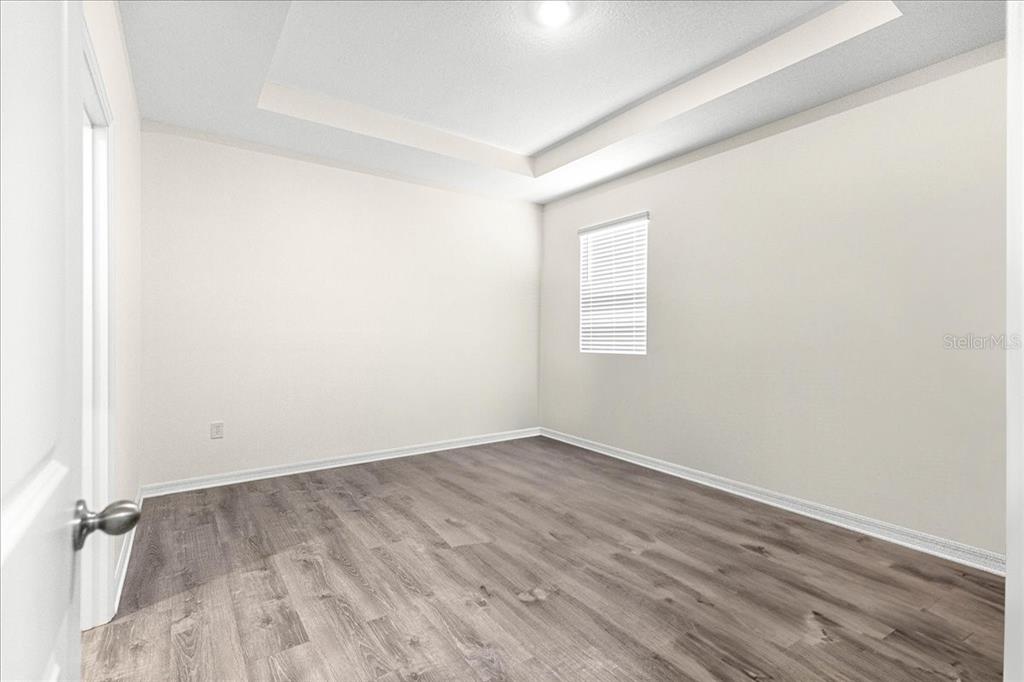 5851 Southwest 85th Place Ocala, FL 34476 - Photo 40 of 57 an empty room with wooden floor and windows