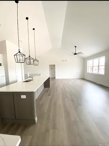a view of a room with wooden floor and window