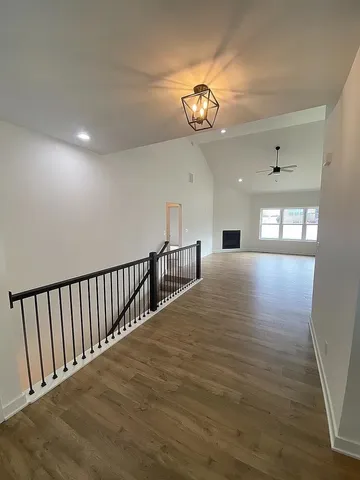a view of a room with wooden floor