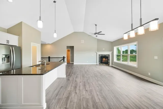 a large kitchen with kitchen island a large counter space a sink appliances and cabinets