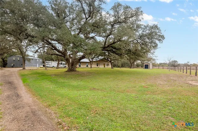 a view of swimming pool with outdoor space and trees