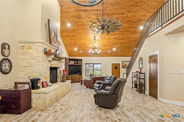 a living room with fireplace furniture and a chandelier