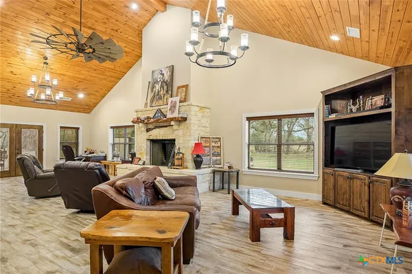 a living room with fireplace furniture and a flat screen tv