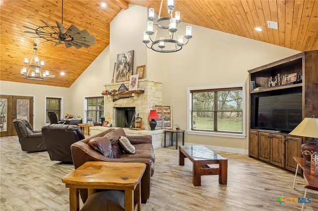 a living room with fireplace furniture and a flat screen tv