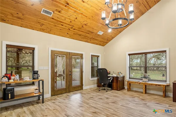a view of a livingroom with furniture and a window