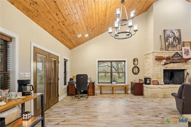 a kitchen with stainless steel appliances kitchen island granite countertop a sink stove and refrigerator