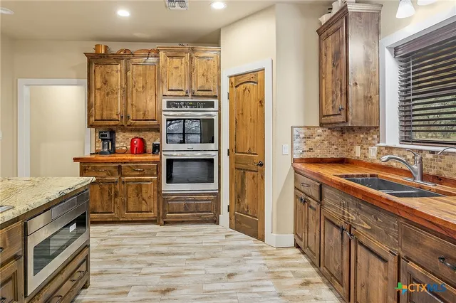 a kitchen with a sink and a window