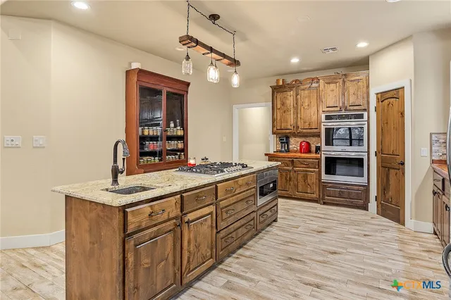 a kitchen with stainless steel appliances sink and refrigerator